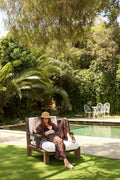 Woman wearing DOTTO Rosaire Kimono Set by pool with lush greenery
