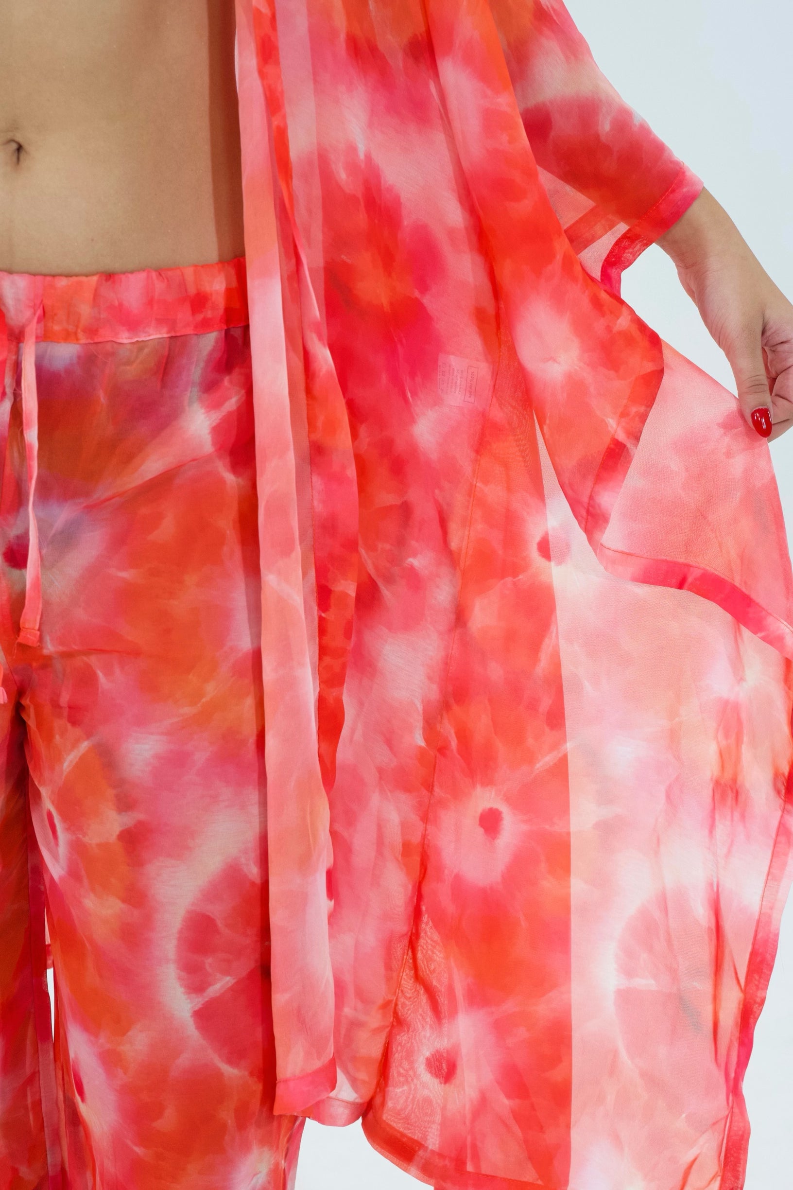 Red and white tie-dye outfit with a blurred background